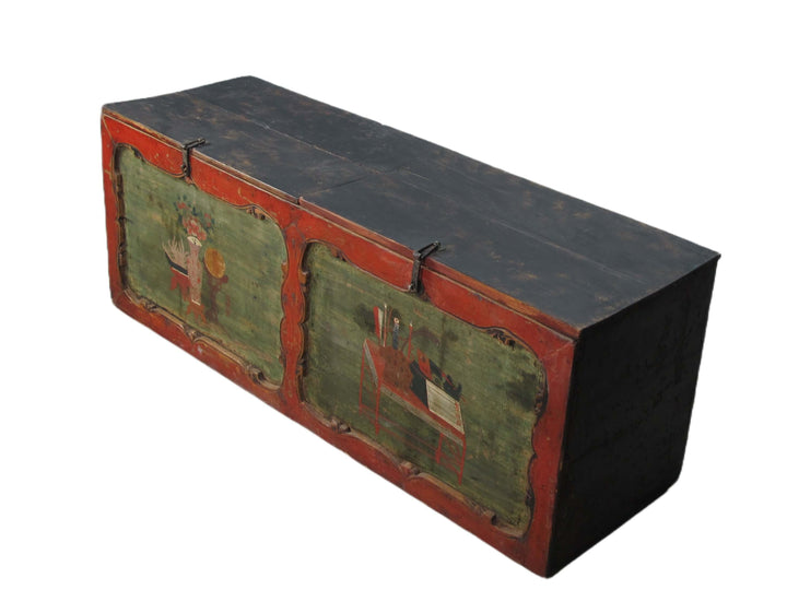 Vintage wooden trunk with green and red paint on a white background