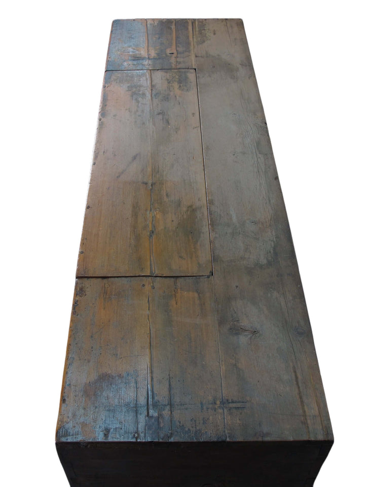 Rustic wooden table with a worn surface on a white background