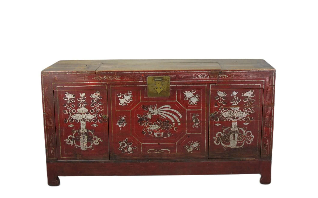 Decorative red chest with intricate white designs on a white background