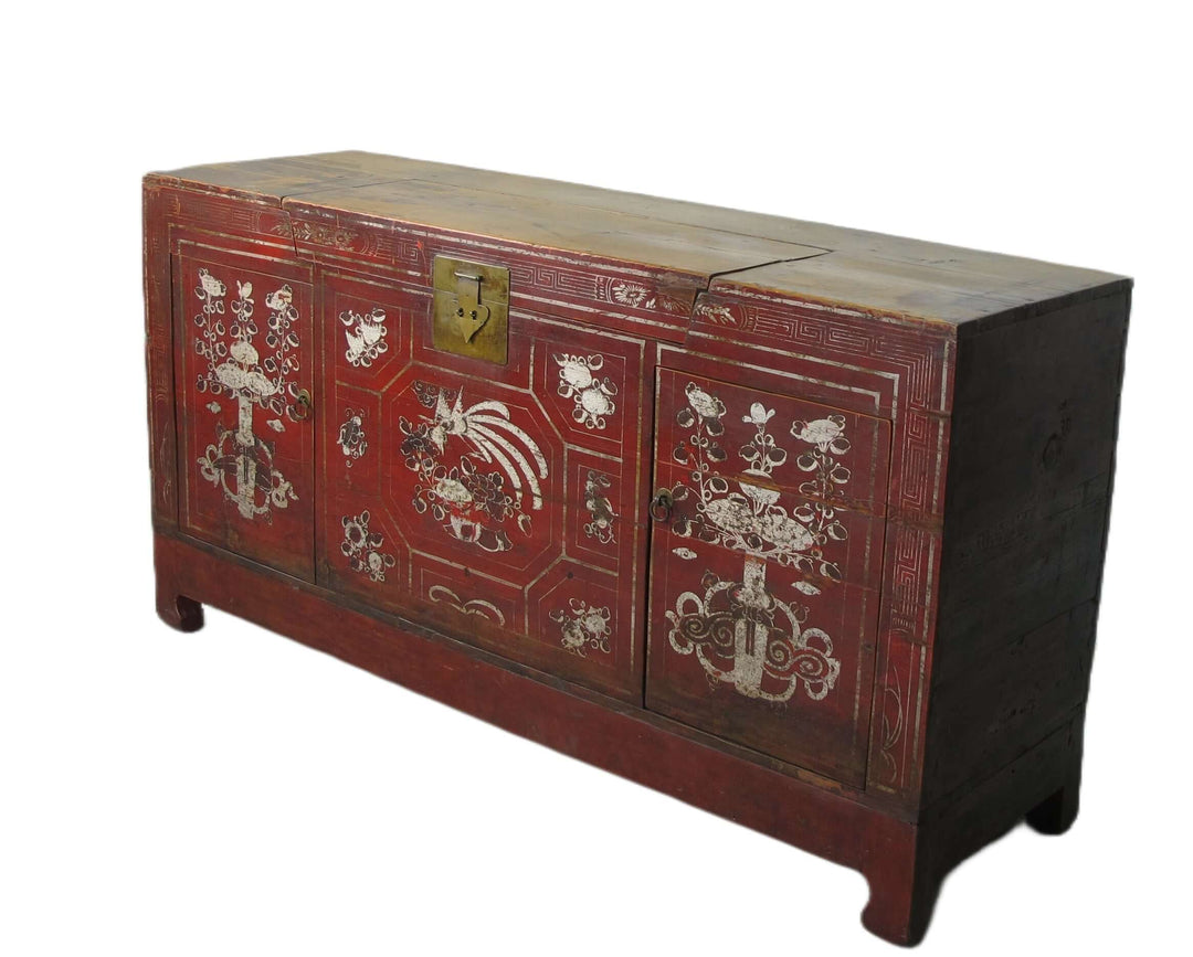 Decorative wooden chest with red paint and white floral patterns on a white background