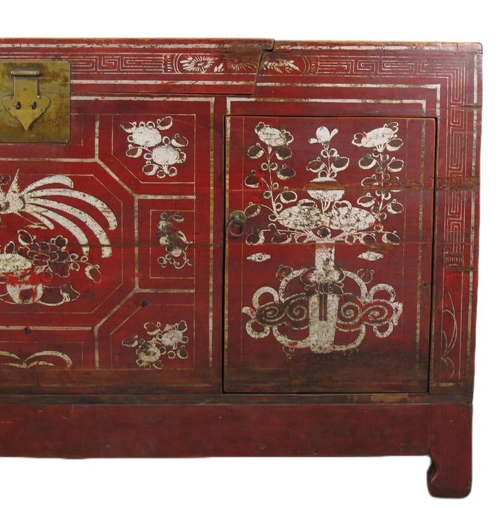 Red wooden cabinet with white decorative patterns on a white background