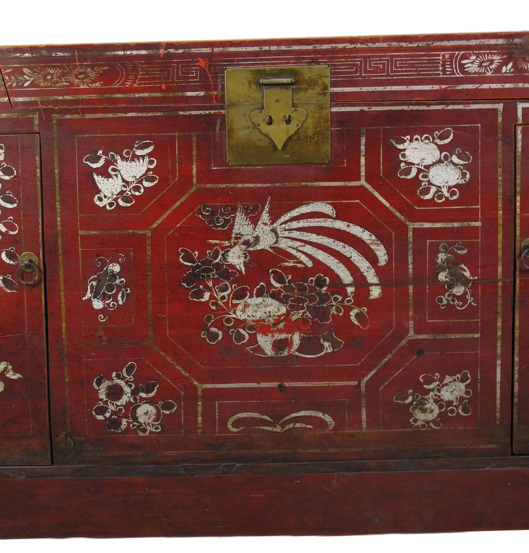 Red wooden cabinet with white decorative patterns on a white background