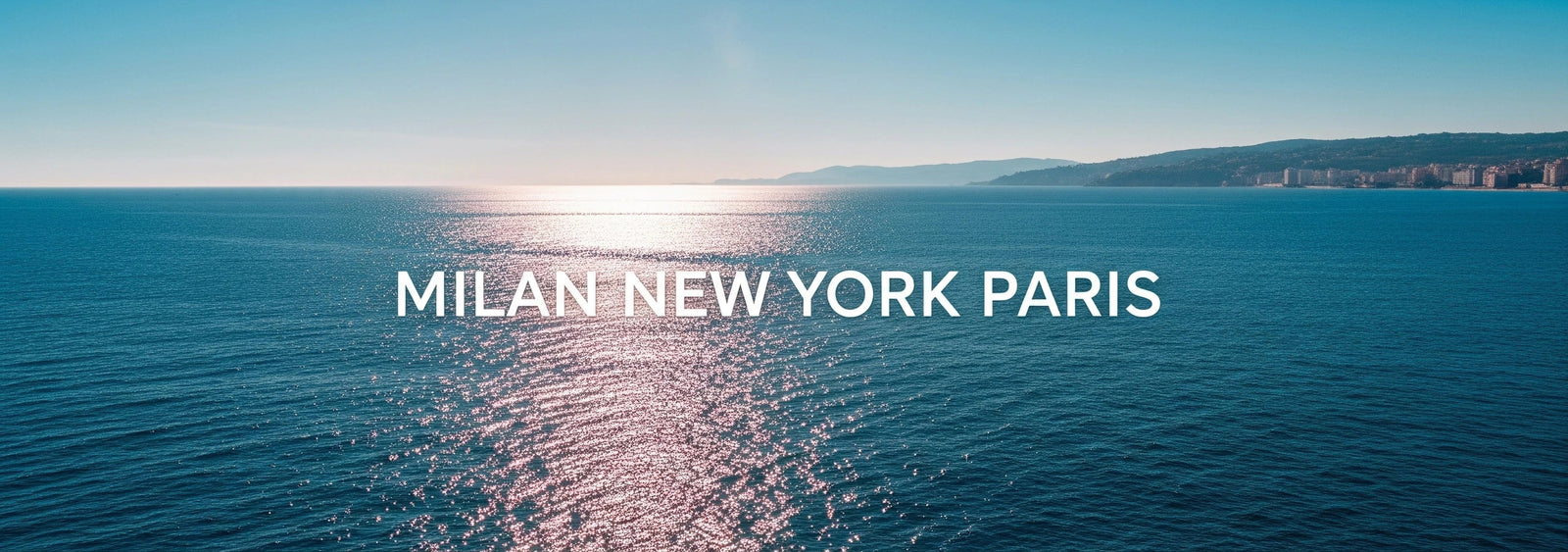 Panoramic view of a blue ocean with a clear sky, featuring the text 'Milan New York Paris'.