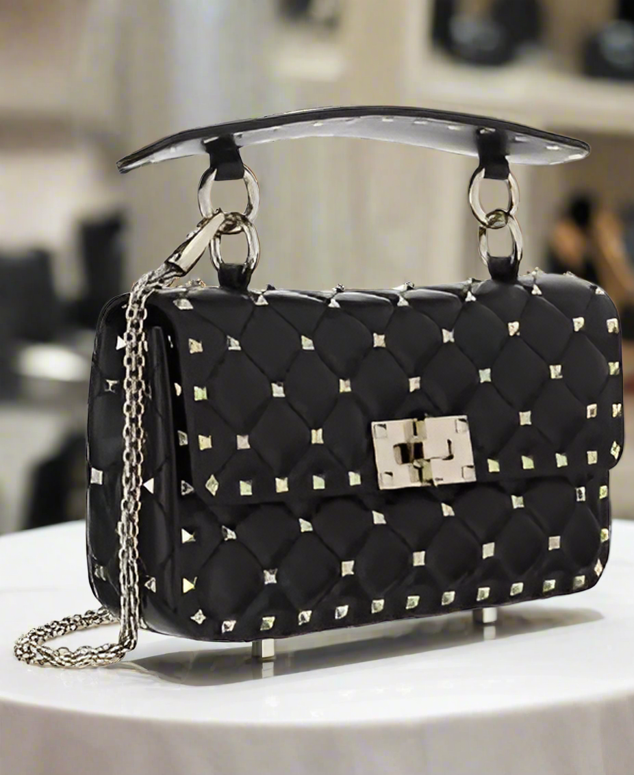 Valentino Garavani women's designer handbag in leather Luxury Valentino Garavani shoulder bag with iconic studs Valentino Garavani crossbody bag in black with gold accents