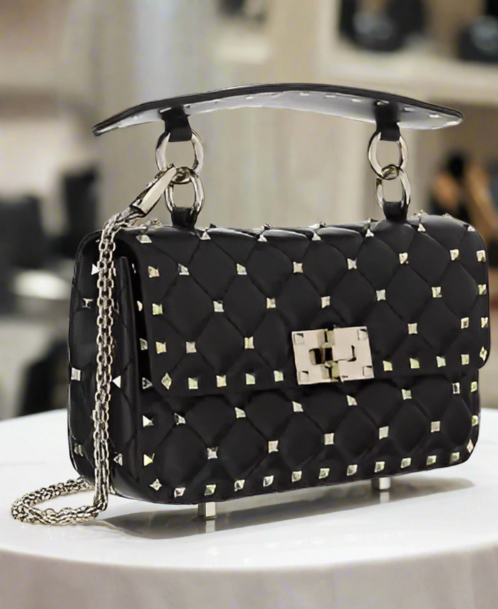 Valentino Garavani women's designer handbag in leather Luxury Valentino Garavani shoulder bag with iconic studs Valentino Garavani crossbody bag in black with gold accents