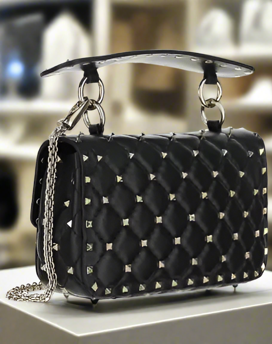 Valentino Garavani women's designer handbag in leather Luxury Valentino Garavani shoulder bag with iconic studs Valentino Garavani crossbody bag in black with gold accents