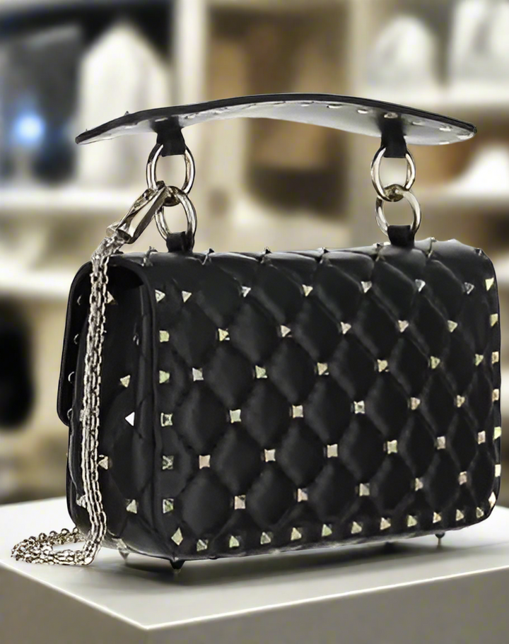 Valentino Garavani women's designer handbag in leather Luxury Valentino Garavani shoulder bag with iconic studs Valentino Garavani crossbody bag in black with gold accents