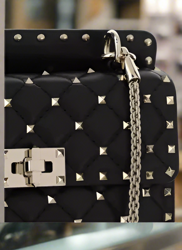 Valentino Garavani women's designer handbag in leather Luxury Valentino Garavani shoulder bag with iconic studs Valentino Garavani crossbody bag in black with gold accents