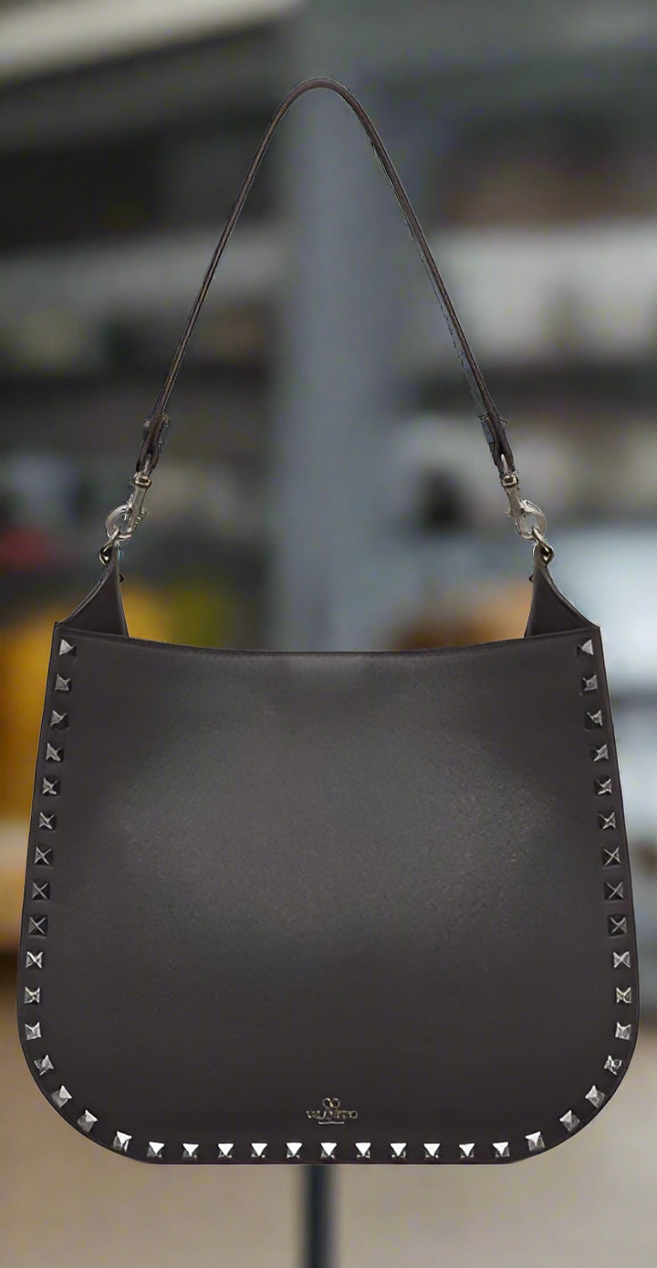 Valentino Garavani women's designer handbag in leather Luxury Valentino Garavani shoulder bag with iconic studs Valentino Garavani crossbody bag in black with gold accents