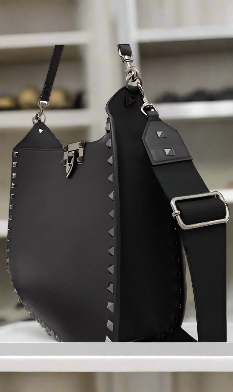 Valentino Garavani women's designer handbag in leather Luxury Valentino Garavani shoulder bag with iconic studs Valentino Garavani crossbody bag in black with gold accents