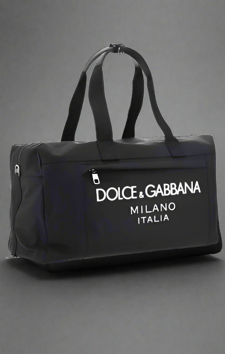 Travel Bag by Dolce&Gabbana, top closure with double-slider zipper, zippered welt pocket on back, iconic brand monogram printed in contrast on front, patch pocket on front panel, removable and adjustable nylon shoulder strap.

