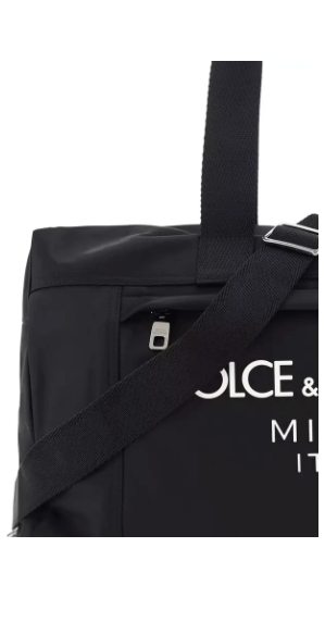 Travel Bag by Dolce&Gabbana, top closure with double-slider zipper, zippered welt pocket on back, iconic brand monogram printed in contrast on front, patch pocket on front panel, removable and adjustable nylon shoulder strap.

