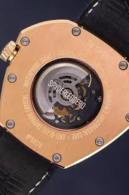 Close-up of a mechanical watch with visible brand name on a dark background