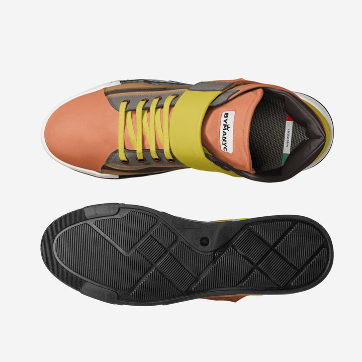 Sneaker with orange side and yellow laces on a white background