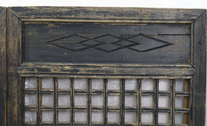 Decorative wooden panel with geometric patterns and glass panels