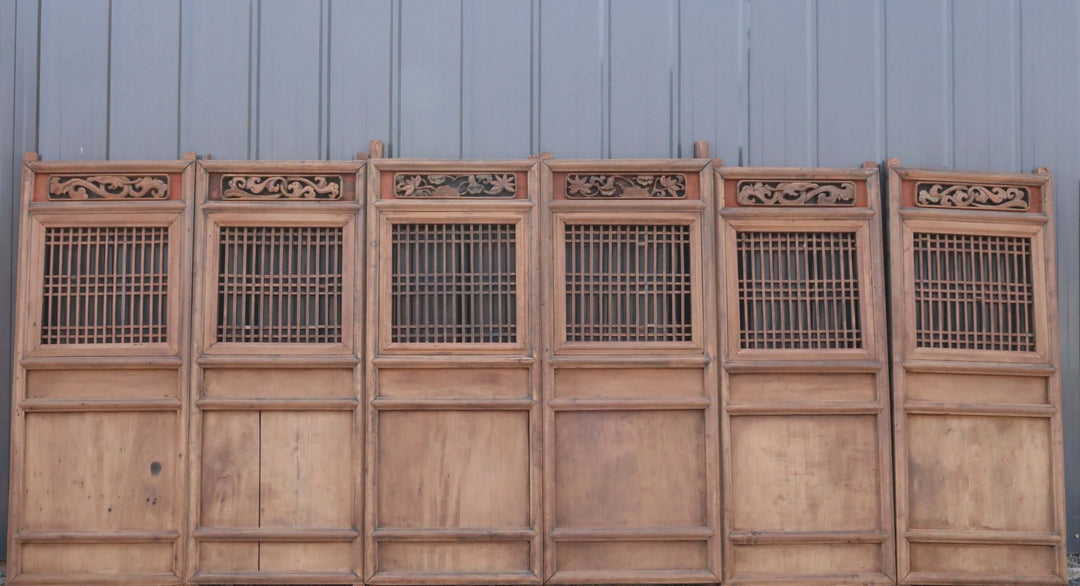 Wooden panel with intricate carvings on a plain background