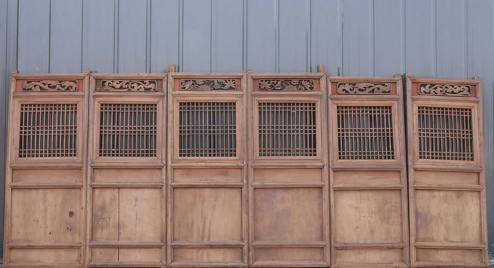 Wooden panel with intricate carvings on a plain background