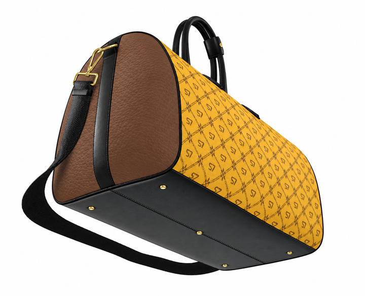 A luxury duffle bag featuring a yellow and black repeating monogram pattern on one half, brown pebbled leather on the other half, and a solid black base and handles, shown on a white background.