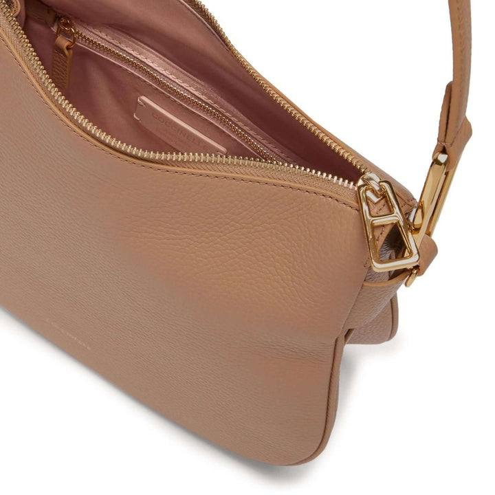 Close-up of a brown leather handbag with gold zipper and strap on a white background