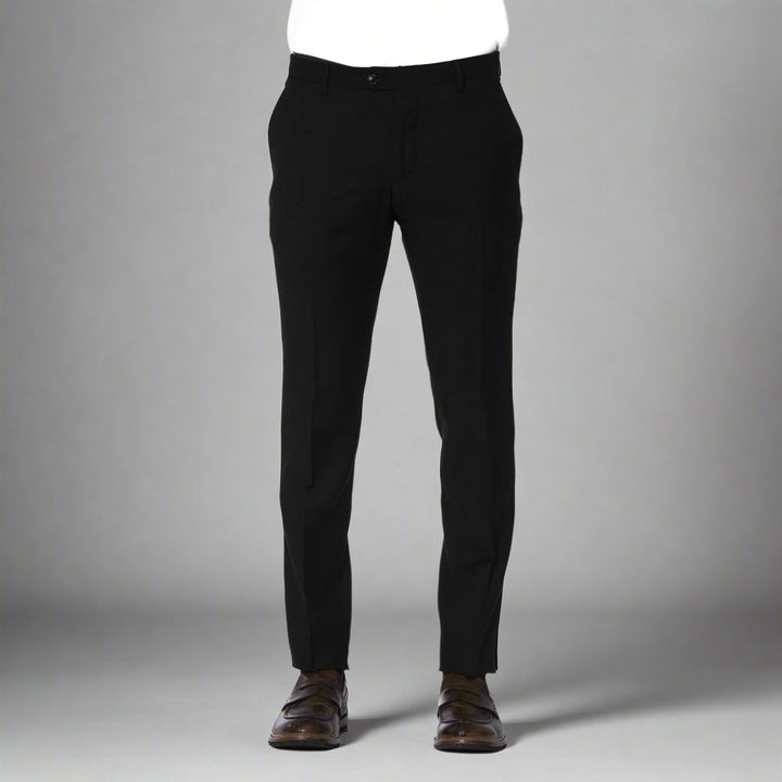 A pair of Trussardi brand trousers displayed on a model, color black, with visible logo on the right pocket, slim fit design, with the model wearing brown shoes.