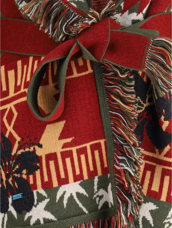 Red patterned fabric with fringes and a bow