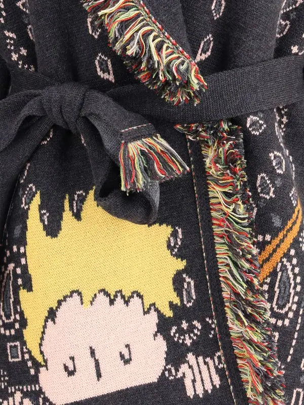 Close-up of a black robe with colorful trim and a cartoon character design.