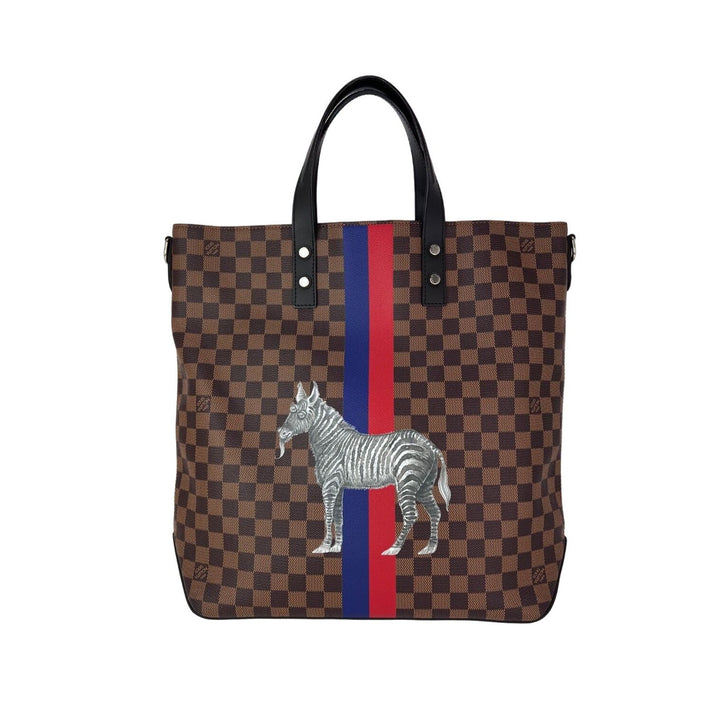 Checkered tote bag with zebra design and red, white, and blue stripe on a white background