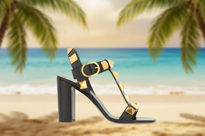 Black sandal with gold studs on a white background