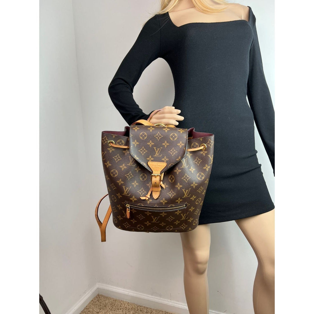 LOUIS VUITTON Montsouris NM Monogram Backpack displayed on mannequin, a stylish luxury bag with leather accents.