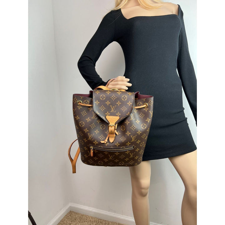 LOUIS VUITTON Montsouris NM Monogram Backpack displayed on mannequin, a stylish luxury bag with leather accents.