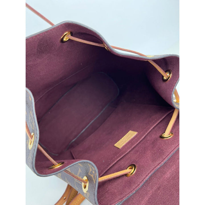 Interior view of LOUIS VUITTON Montsouris NM Monogram Backpack showing marron microfiber lining and flat pocket.
