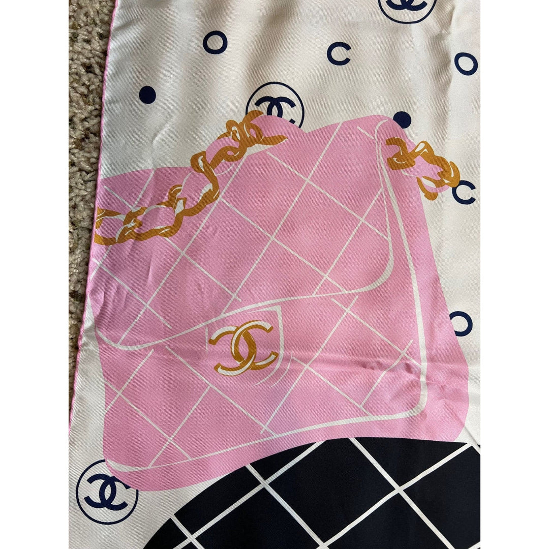 Pink Chanel scarf with logo on a white background
