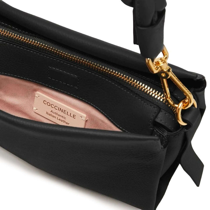 Black handbag with gold zipper and Coccinelle label on a white background