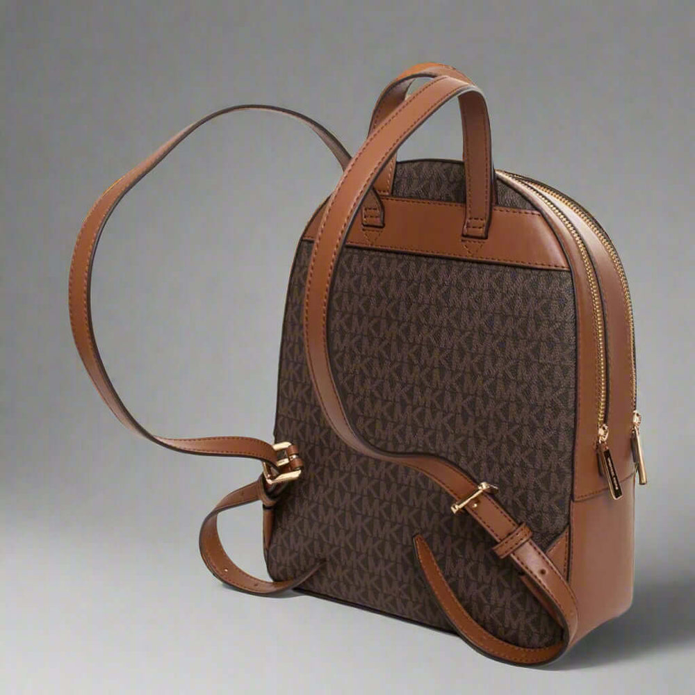 Brown backpack with gold accents on a white background