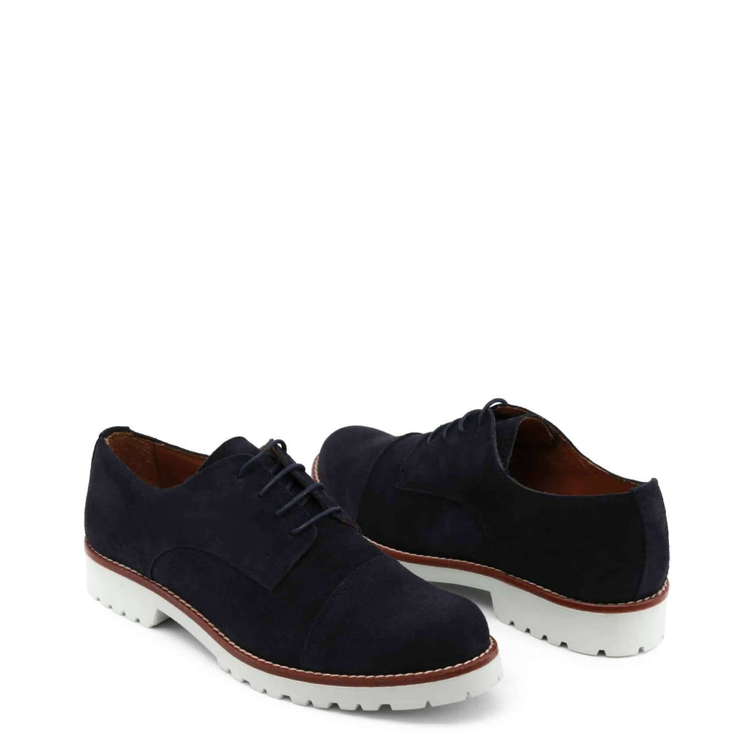 Pair of black suede shoes with white soles on a white background