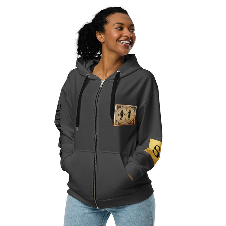 Woman in grey hoodie with graphic front patch and "S"on left arm.