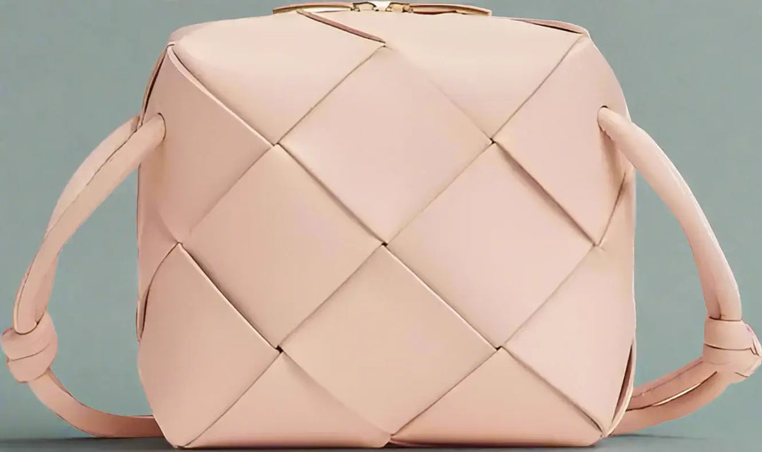 Pink woven handbag on a white background