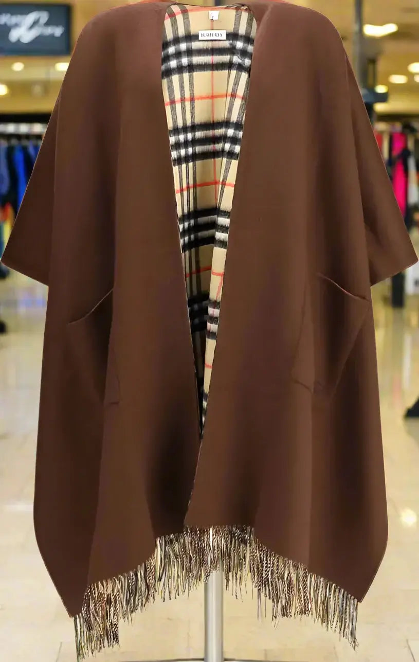Brown poncho with plaid lining on a white background