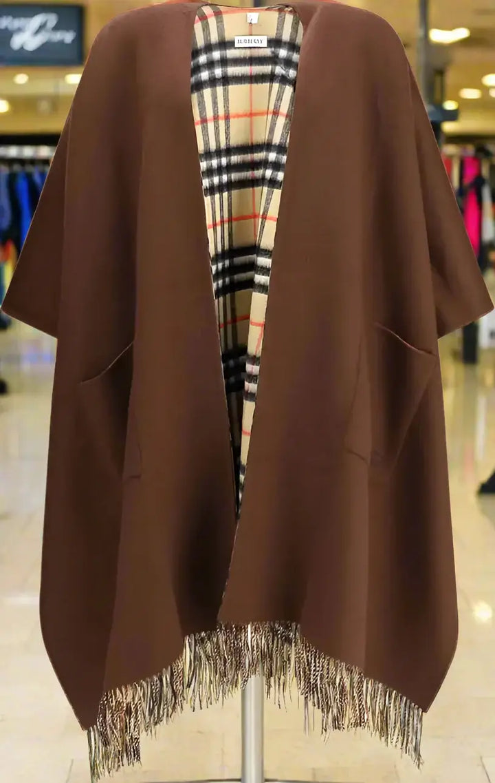 Brown poncho with plaid lining on a white background