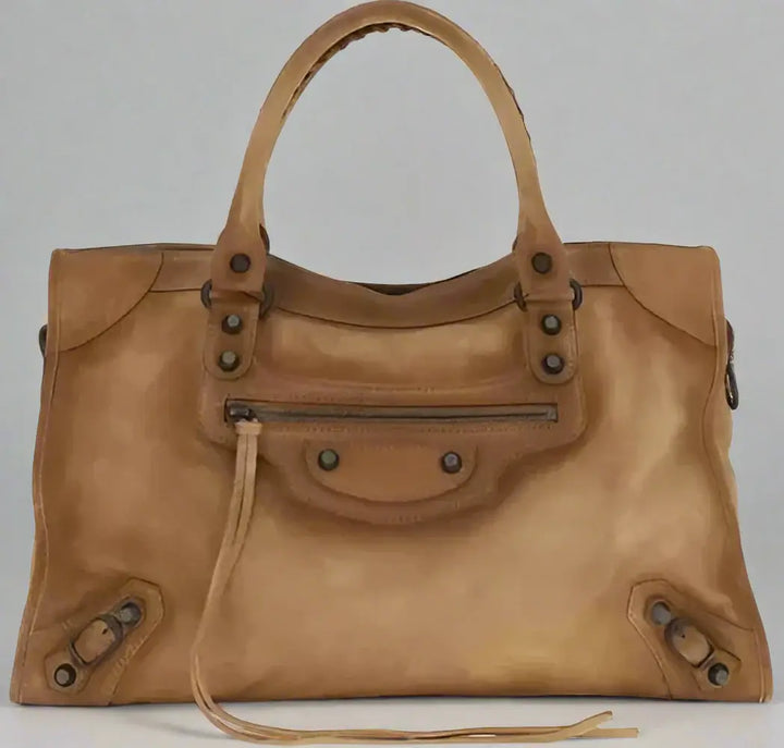 Brown leather handbag with visible brand logo on a white background
