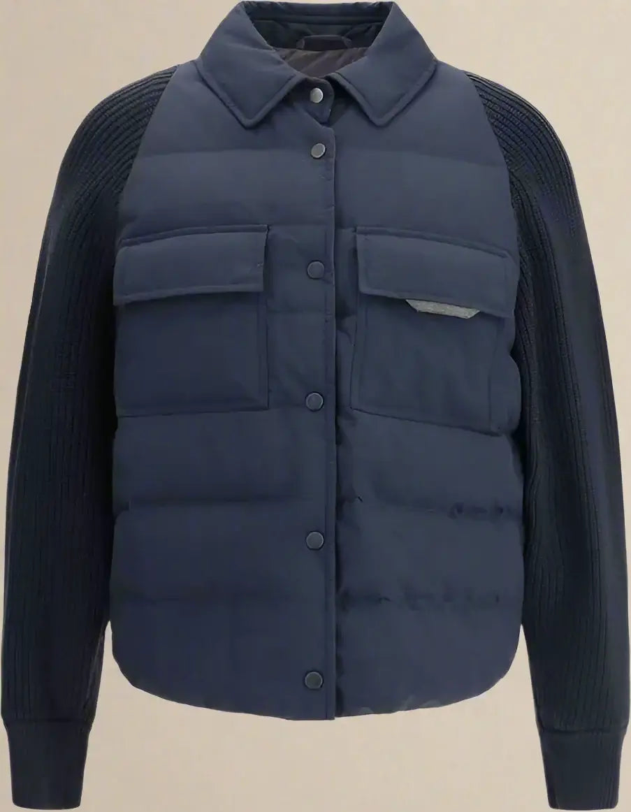 Navy puffer vest over a dark sweater on a white background