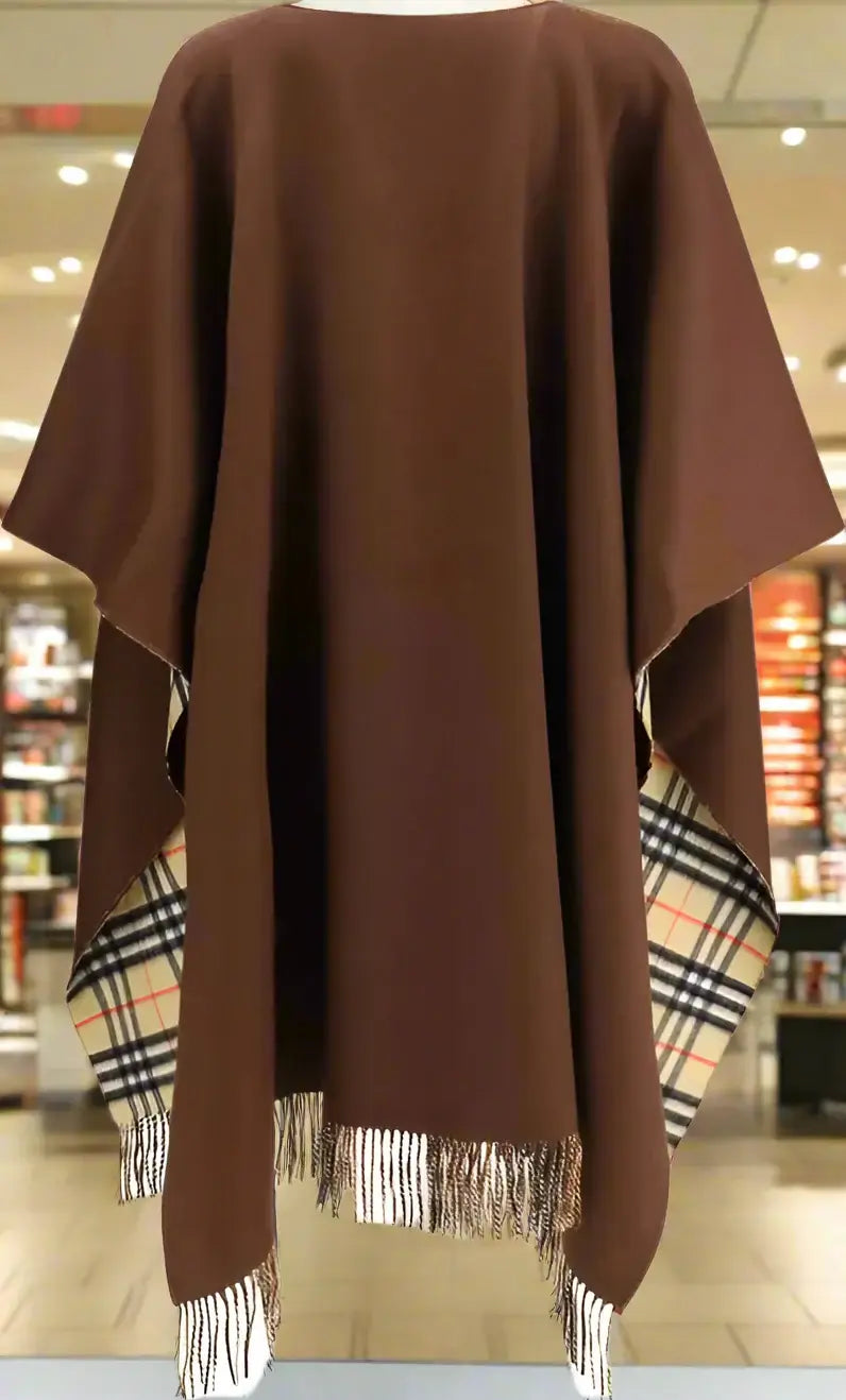 Brown poncho with plaid pattern at the hem on a white background
