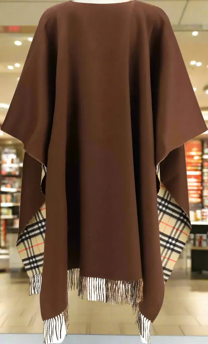 Brown poncho with plaid pattern at the hem on a white background