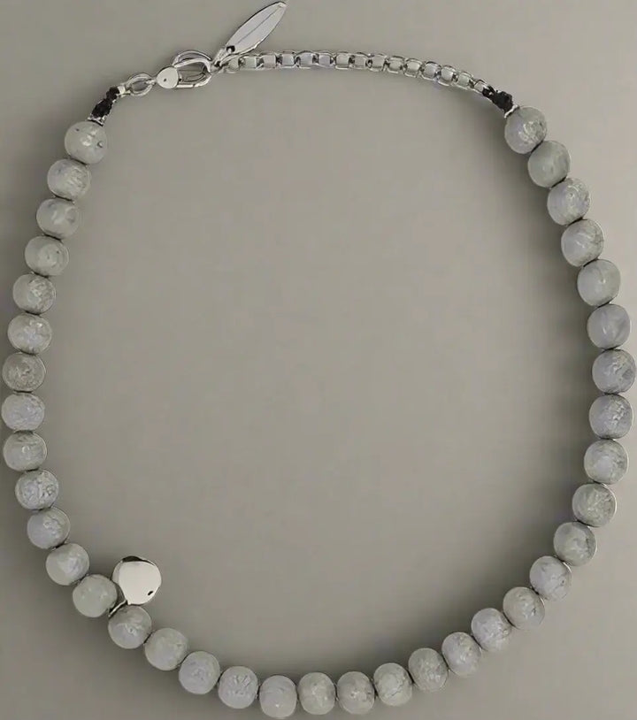 Necklace with gray beads on a white background