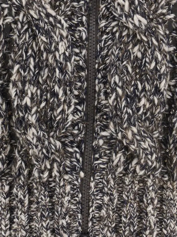 Close-up of a textured fabric with a zipper running vertically through it.