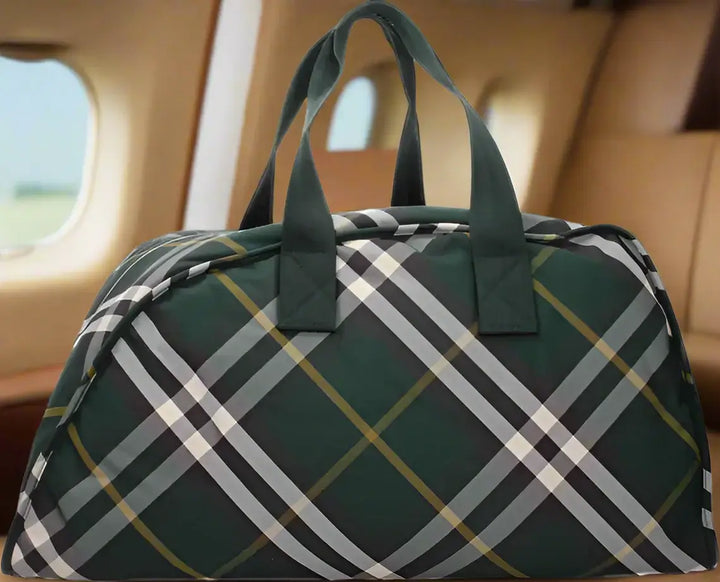 Green plaid duffel bag on a white background