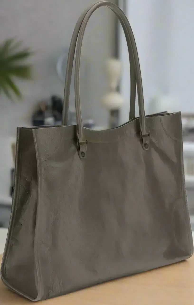 Dark brown tote bag with handles on a white background