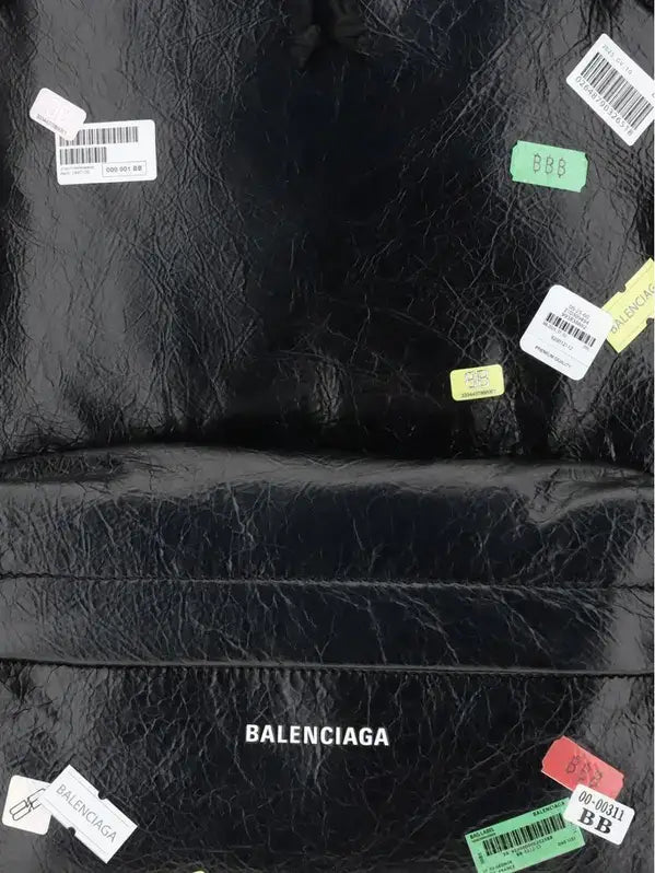 Black leather Balenciaga bag with visible branding and tags.