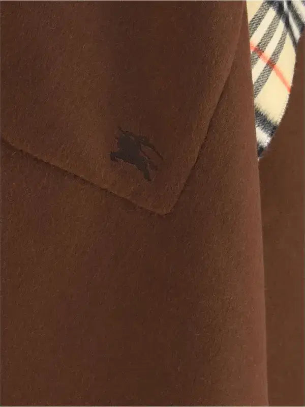 Brown coat with a brand logo on the chest pocket, plaid pattern visible.