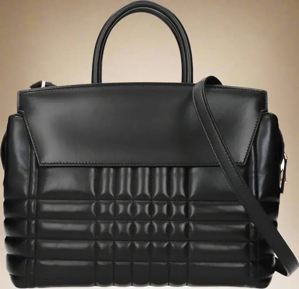 Black quilted handbag with a shoulder strap on a white background